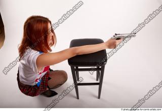 36 2018 01 TINA KNEELING POSE WITH GUNS